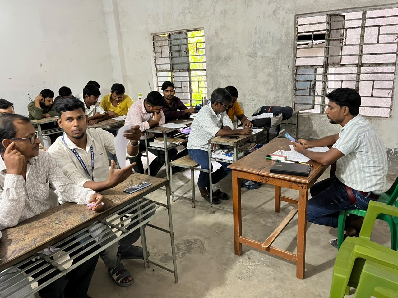 Teachers talking around desks in a classroom